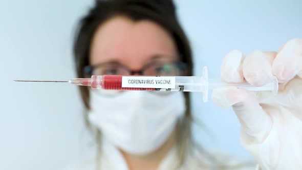 Nurse Holding Corona Flu Vaccine in Syringe