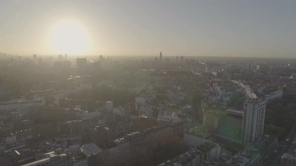 Brightly shining sun over the horizon hitting the rooftops and buildings of Knightsbridge district i