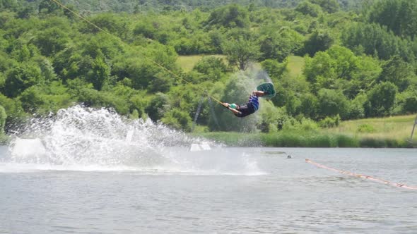 Slow Motion View of Extreme Wakeboarder Doing Tricks and Falling in the Water