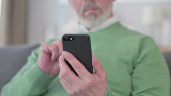 Close Up of Old Man Hands Using Smartphone