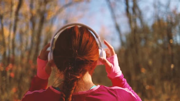 Active Run Woman with White Headphones Running Outdoors in Nature Autimn Fall for Achieving Her