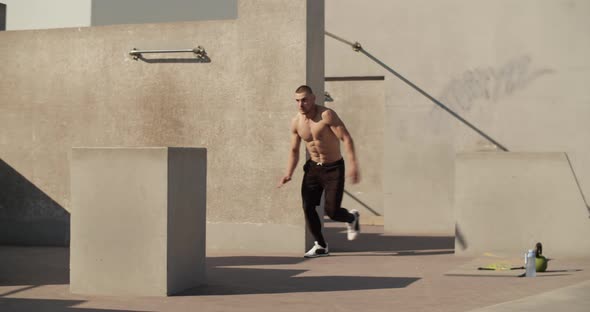 Male Athlete Leaping Over Barrier