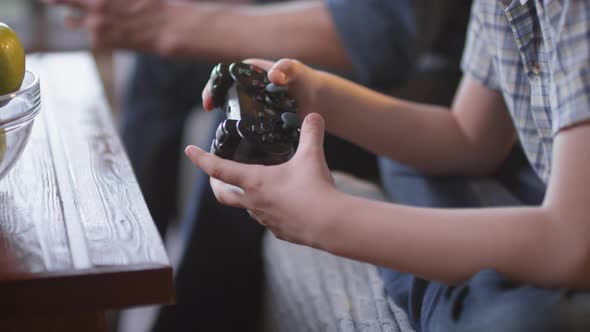 Hands of Father and Son Playing Video Game