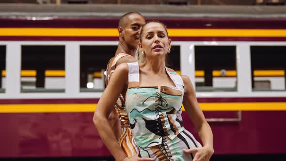 Fashion Models Posing In Patterned Clothing In Train Station