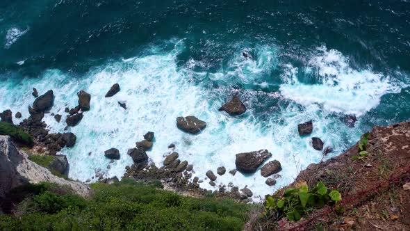 Top View of the Ocean Shore with Waves Crashing on Rocks