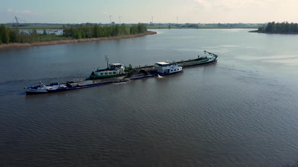 Dredging ship dredges off mud from river bottom to improve the fairway