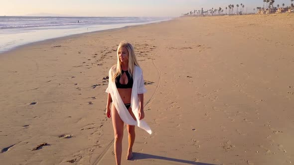 Attractive Blond Woman Walking on the Beach