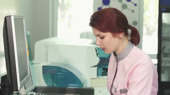 Beautiful Young Woman Working at the Laboratory