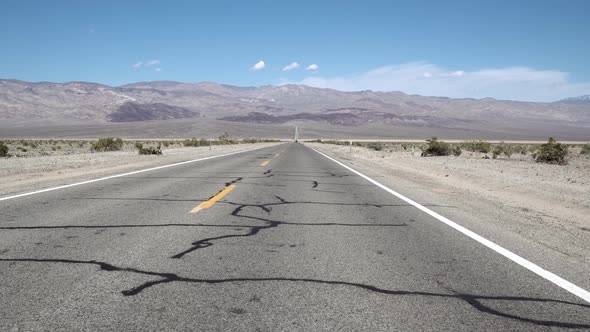 Highway crossing Death Valley, Mojave Desert, California, Aerial Dolly left shot