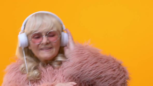 Cool Grandmother in White Headphones Moving to Music, Pretending Be Dj, Fun