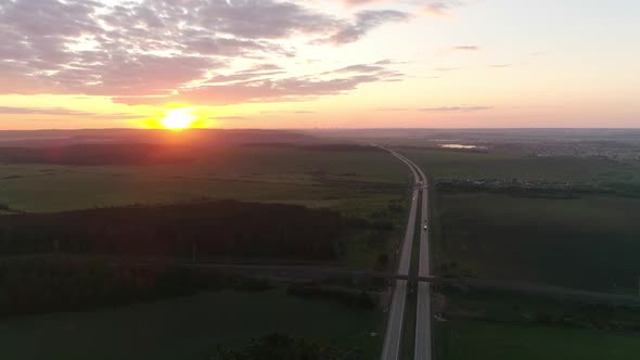 Aerial view of evening highway and fields at sunset 04