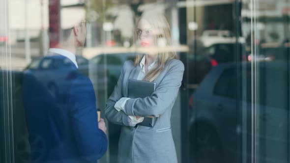Businessman and businesswoman talking in office building