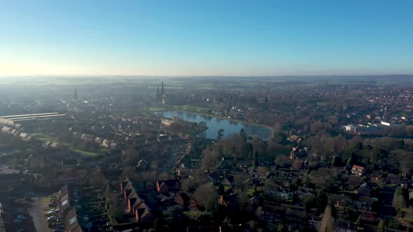 Aerial view of a city with its cathedral and a lake in the early morning