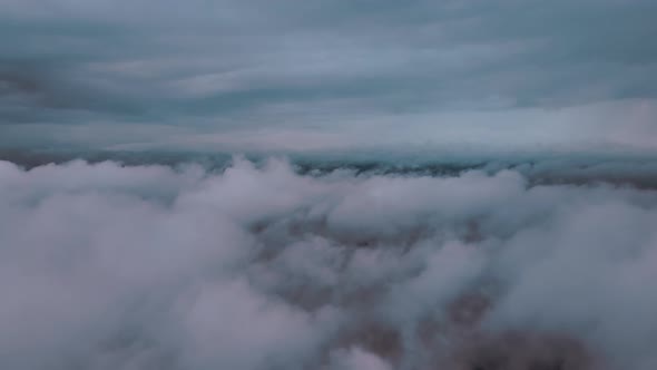 Aerial View From Airplane Window at High Altitude of Earth Covered with Puffy Cumulus Clouds Forming