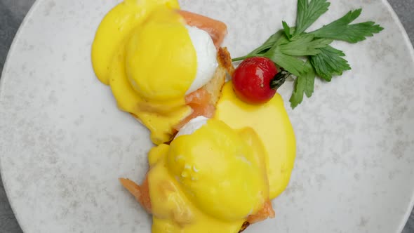 Breakfast Eggs Benedict with Hollandaise Sauce Smoke Salmon in Restaurant Cafe