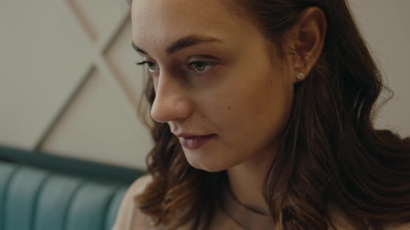 Close Up Portrait of Young Woman Sit at Cafe