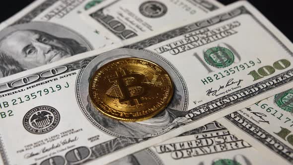 Closeup of Dollar Bills and Bitcoins Rotate