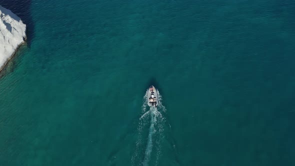 Overhead Top Down Birds Aerial View of Small Motor Boat on Crystal Clear Water