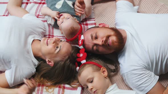 New Year - Family Is Lying on a Blanket Talking and Smiling