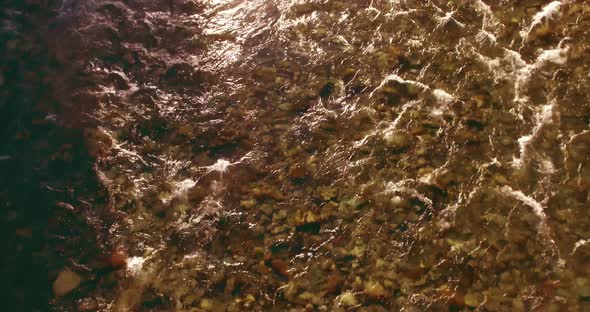 Low Altitude Flight Over Fresh Fast Mountain River with Rocks at Sunny Summer Morning.