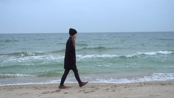 The Girl Walks on the Beach