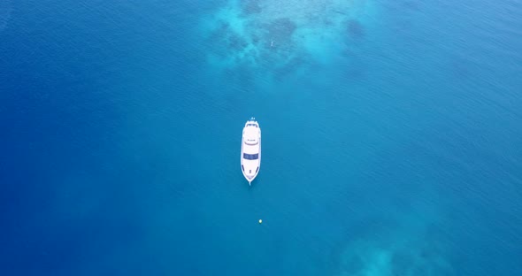 Tropical flying abstract shot of a white paradise beach and blue water background in 4K