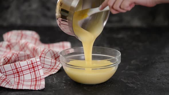 Pouring Vanilla Pudding Into Bowl.