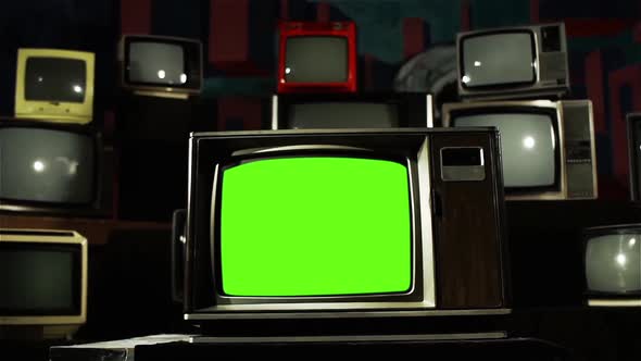Old Television Set with Green Screen Among Retro TV Wall. Dolly Out.