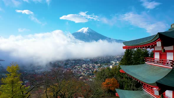 Aerial view 4k footage of Mount Fuji and mist view from behind Chureito Pagoda