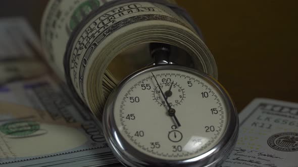Dollars and stopwatch. Business concept of lost time and failed investments