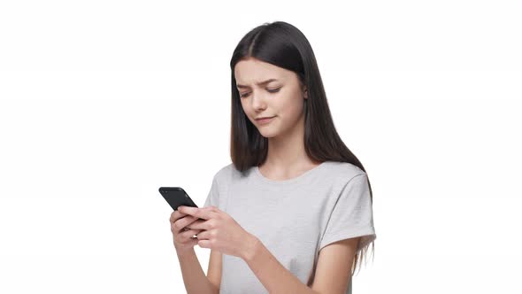 Portrait of Happy Teenage Woman 20s Wearing Casual Clothing Holding Smartphone and Typing Text