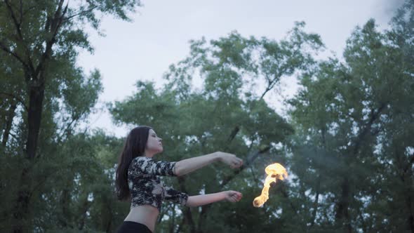 Portrait Cute Confident Woman Performing a Show with Flame Standing in the Forest or Park