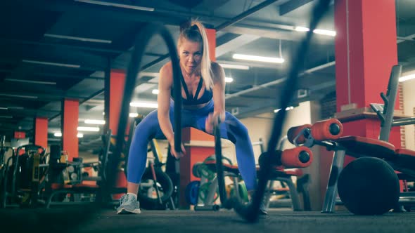 One Sportswoman Does Crossfit, Using Ropes.