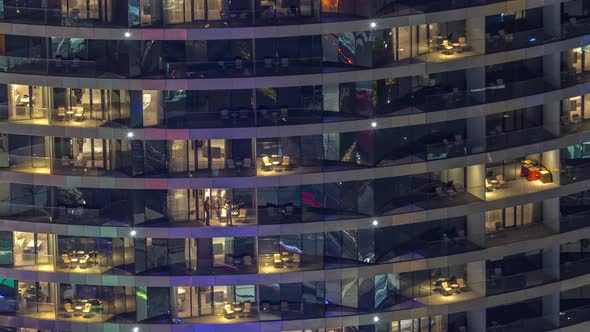 Outside View of Windows in Apartments of a High Class Building at Night Timelapse