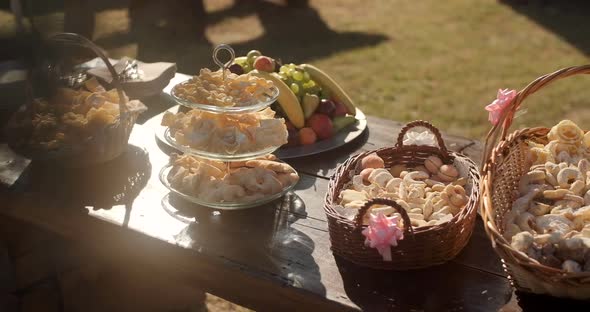 Party table with drinks and sweets . Wedding decor at an exit ceremony