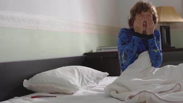 Portrait of Cute Little Boy Waking Up in the Morning with Messy Hair and Wearing Pyjama. Child Wakes