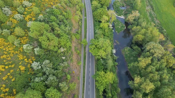 tilting drone shot over a road in the green hills near hesse germany