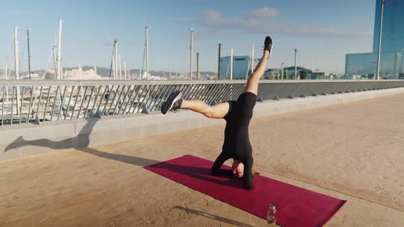 Woman Doing Salamba Sirsasana on Mat