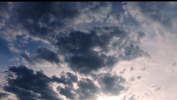 Dark clouds moving at sunset. Static, low angle