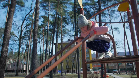 Girl Sliding On The Playground alt
