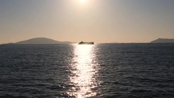 Ferryboat Silhouette Sailing on Sea of Marmara on Sunny Evening. Sun Reflection and Distant Islands
