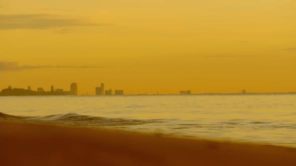 Middle to high waves at the beach and the light of sunrise in the morning