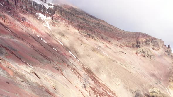 Aerial view of a beautiful slope and the start of a gletser on a vulcano with many different colors 