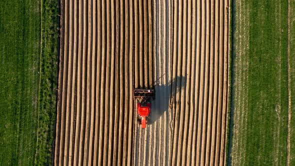 Aerial View of Tractor Performs Seeding on the Field