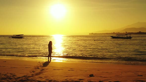 Young fun woman on vacation enjoying life on beach on summer white sand and blue background 4K