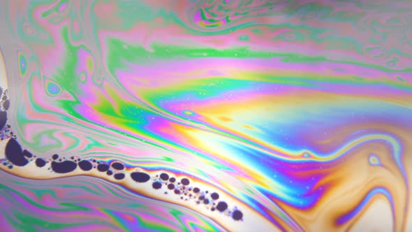 Dark Colored Bubbles Moving in Line, Floating Through Rainbow Liquid in Pattern. Spirituality