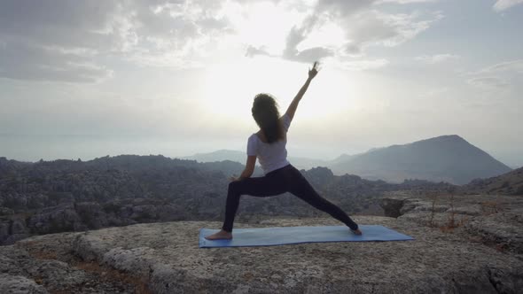 Unrecognizable woman practicing balancing yoga asana in nature