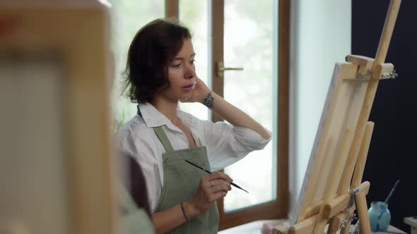 Female Students Painting at Art Lesson in Art Studio