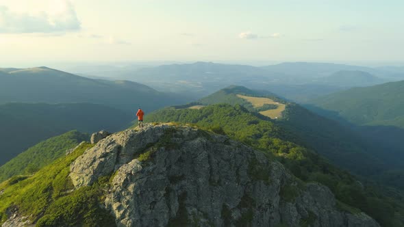 Single Male Hiker Walking on Rocky Edge Descending From Botev Peak Bulgaria