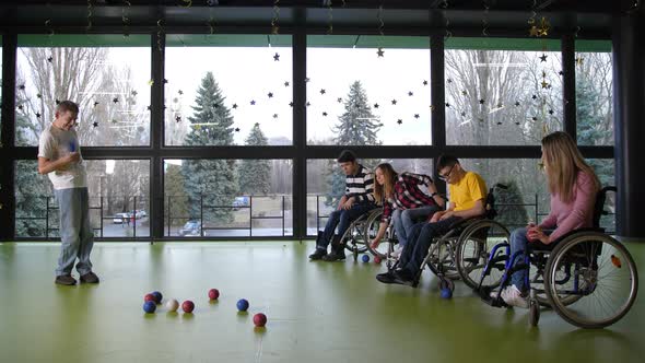 Two Teams of Disabled People Playing Boccia Indoor